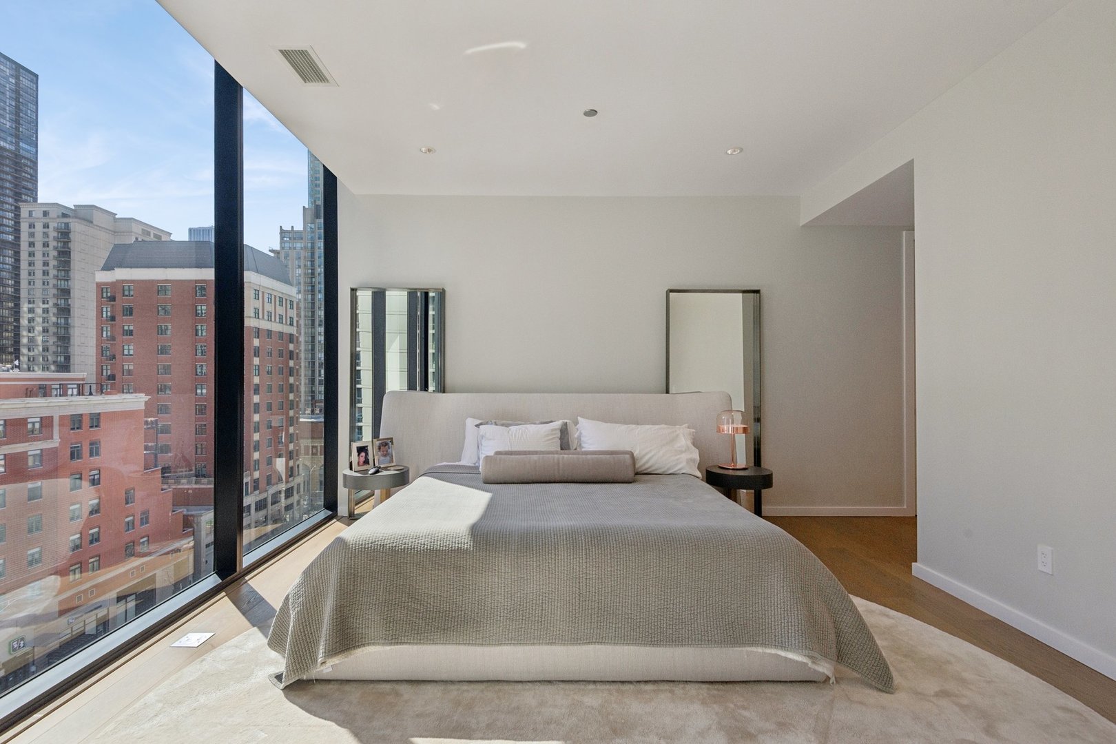56 West Huron Street, Unit 9 Chicago, IL 60654 - Photo 23 of 38 a bedroom with a large bed and a large window