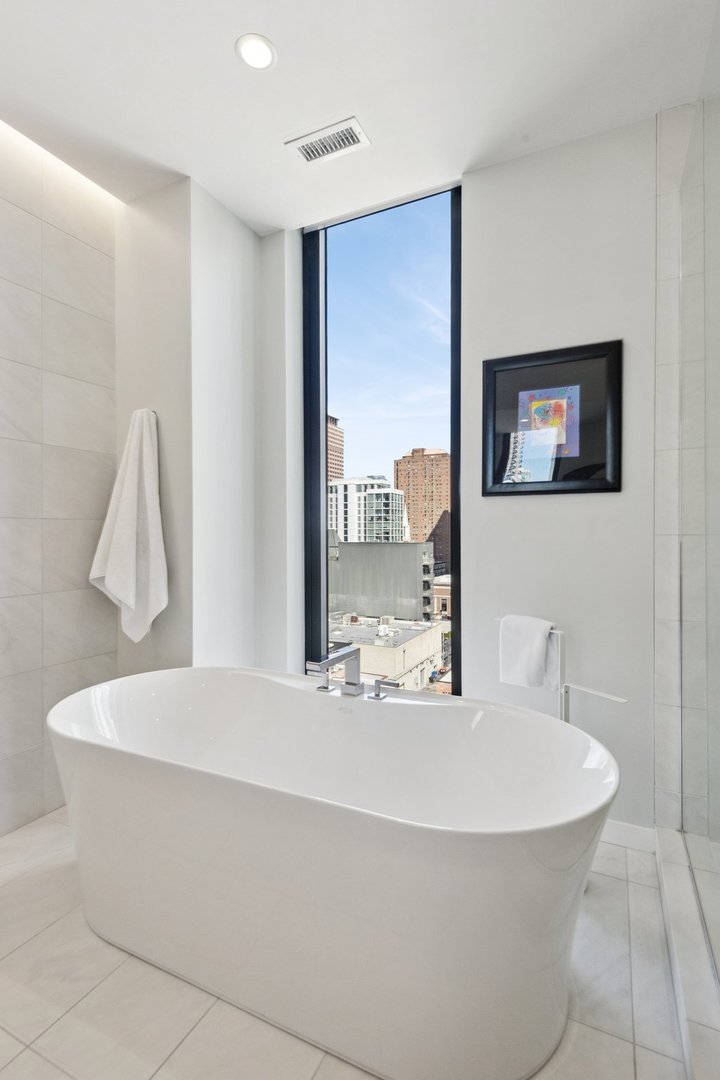 56 West Huron Street, Unit 9 Chicago, IL 60654 - Photo 27 of 38 a bathroom with a bathtub and a sink
