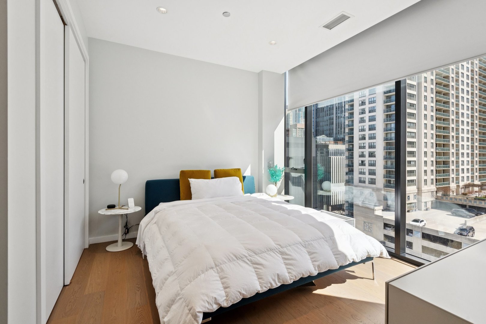 56 West Huron Street, Unit 9 Chicago, IL 60654 - Photo 28 of 38 a bedroom with a bed and a large window