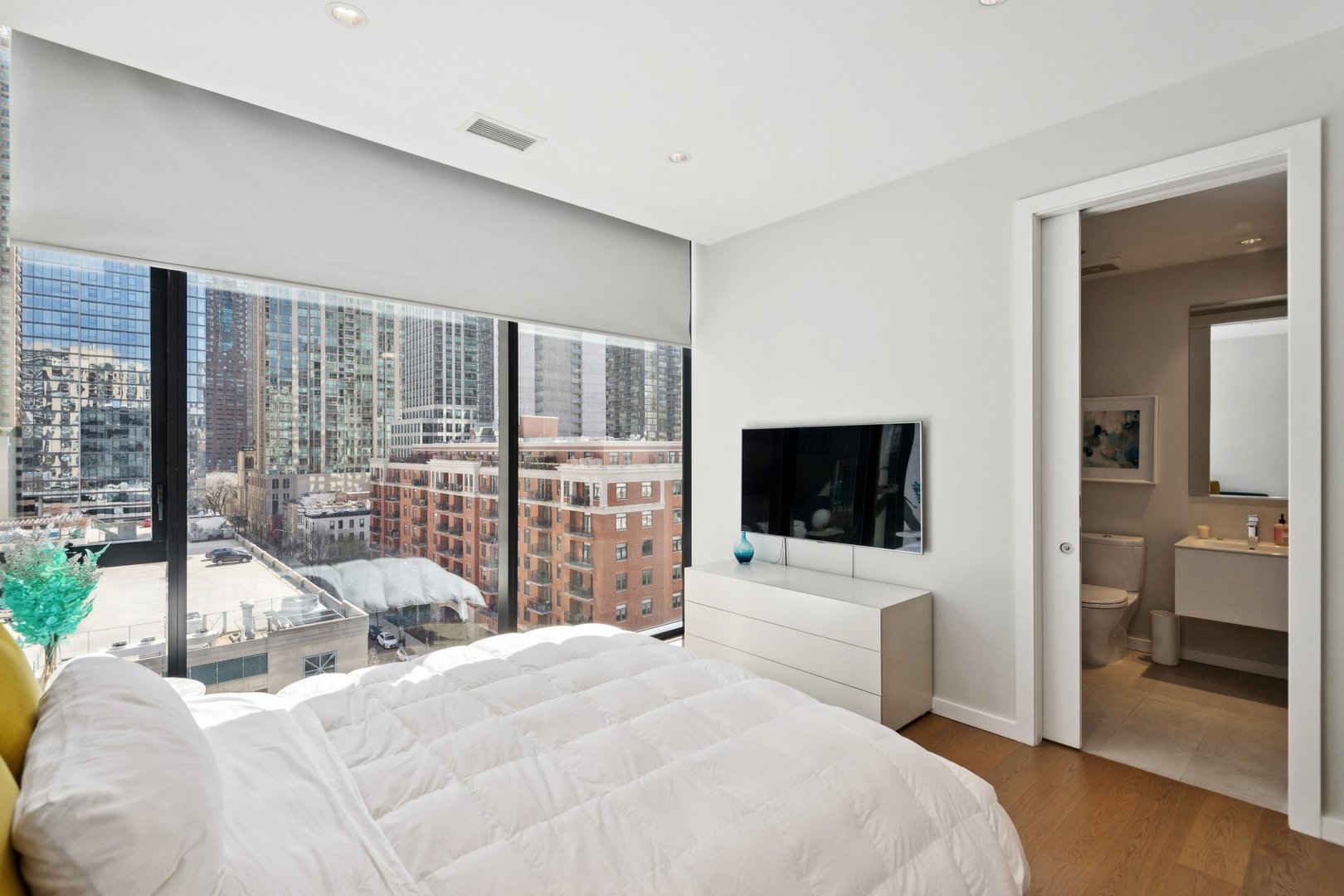56 West Huron Street, Unit 9 Chicago, IL 60654 - Photo 29 of 38 a bedroom with a bed and large window