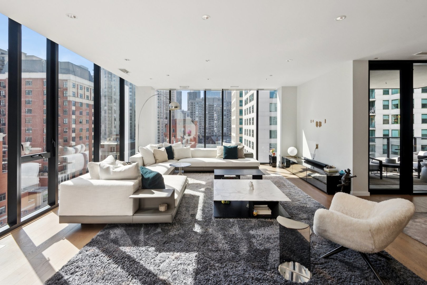 56 West Huron Street, Unit 9 Chicago, IL 60654 - Photo 3 of 38 a living room with furniture and large windows