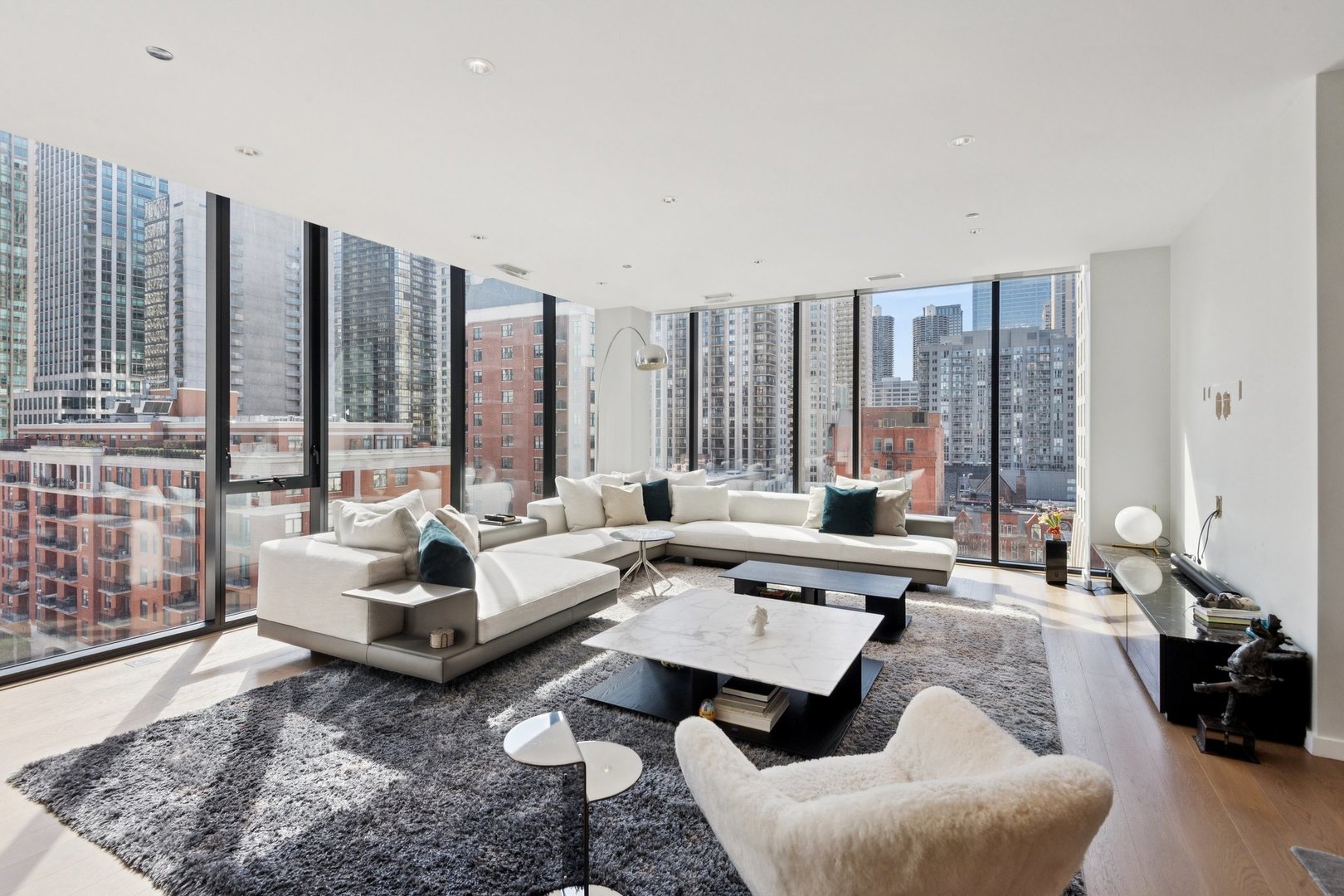 56 West Huron Street, Unit 9 Chicago, IL 60654 - Photo 4 of 38 a living room with furniture and large windows