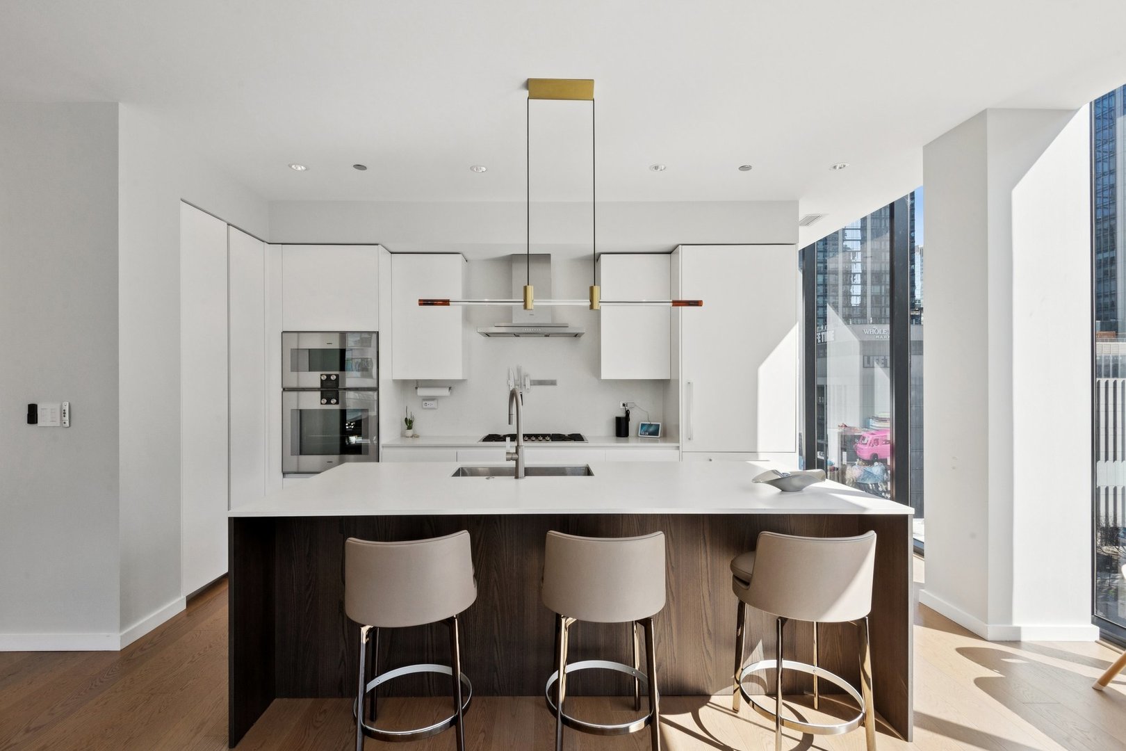 56 West Huron Street, Unit 9 Chicago, IL 60654 - Photo 9 of 38 a view of kitchen island with stainless steel appliances kitchen island granite countertop furniture and a refrigerator