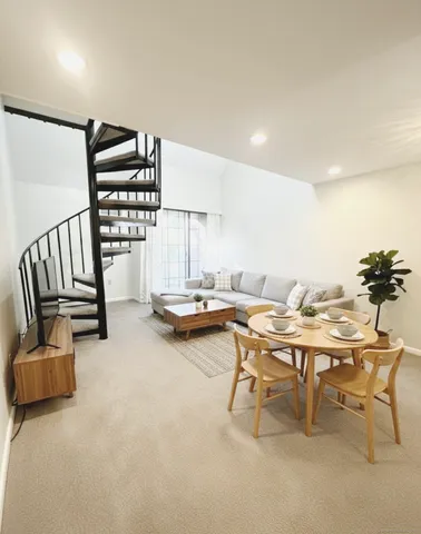 a living room with furniture and a night stand