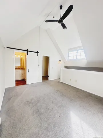 a view of a livingroom with a ceiling fan and window