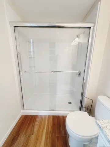 a bathroom with a toilet and a shower