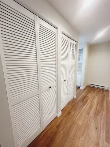 a view of a room with wooden floor