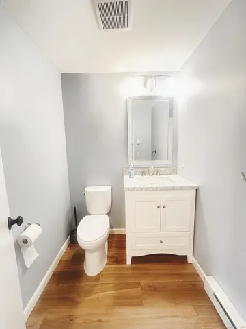 a bathroom with a sink toilet and a mirror