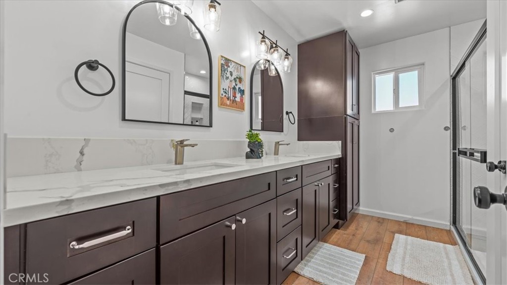1475 North Holly Avenue Colton, CA 92324 - Photo 13 of 45 a spacious bathroom with a double vanity sink and a mirror