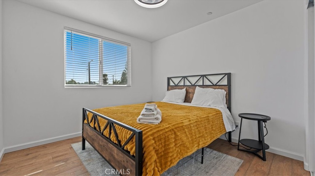 1475 North Holly Avenue Colton, CA 92324 - Photo 14 of 45 a bedroom with a bed and wooden floor