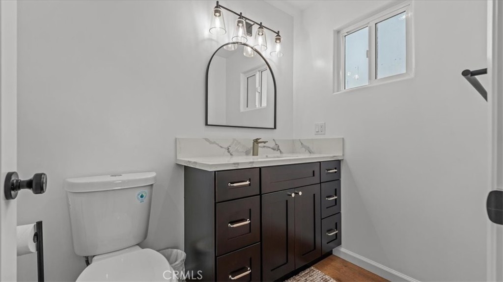 1475 North Holly Avenue Colton, CA 92324 - Photo 16 of 45 a bathroom with a toilet a sink and mirror