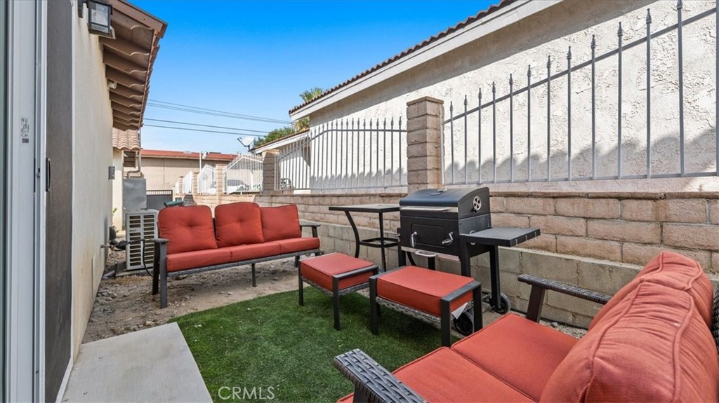 1475 North Holly Avenue Colton, CA 92324 - Photo 18 of 45 a outdoor living space with furniture and a rug