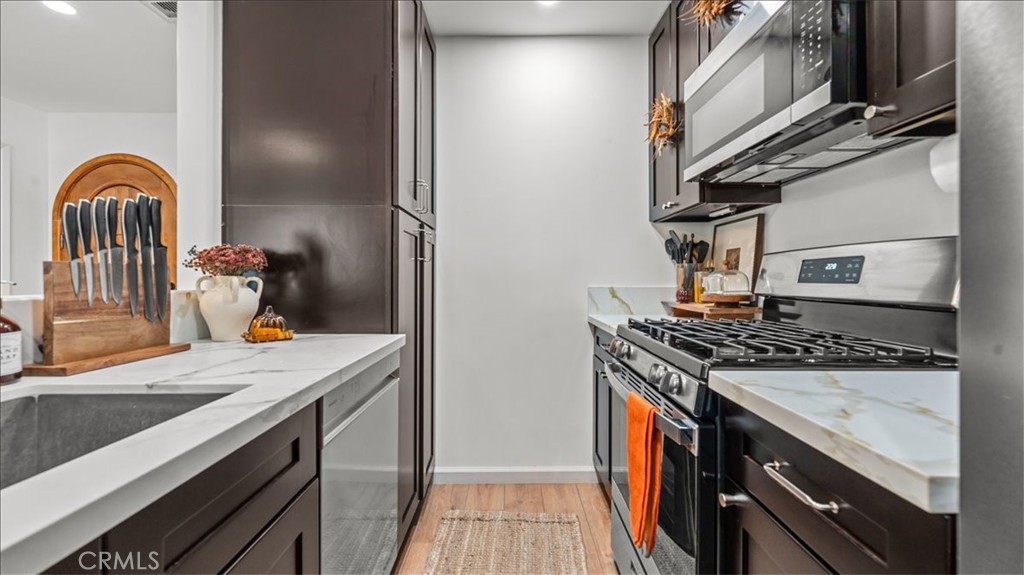 1475 North Holly Avenue Colton, CA 92324 - Photo 22 of 45 a kitchen with stainless steel appliances granite countertop a stove and a sink