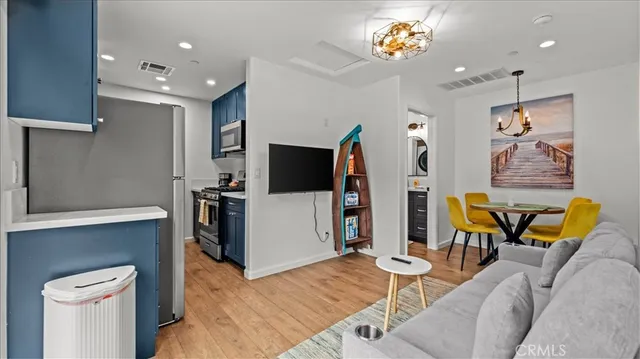 a kitchen with stainless steel appliances granite countertop a sink stove and cabinets