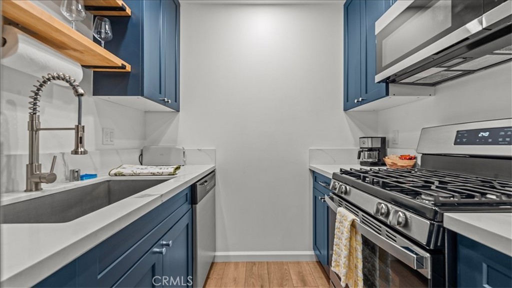1475 North Holly Avenue Colton, CA 92324 - Photo 24 of 45 a kitchen with stainless steel appliances granite countertop a sink stove and cabinets