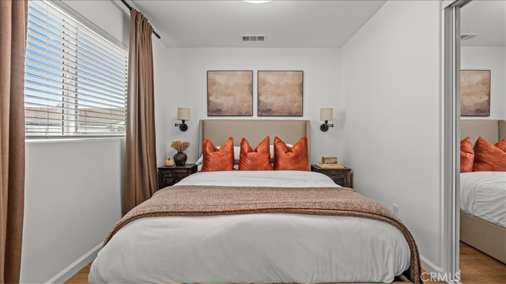 1475 North Holly Avenue Colton, CA 92324 - Photo 34 of 45 a bed sitting in a bedroom next to a window