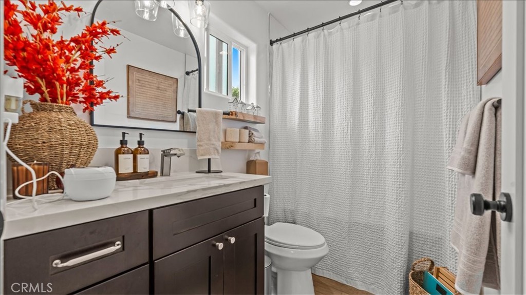 1475 North Holly Avenue Colton, CA 92324 - Photo 35 of 45 a bathroom with a granite countertop sink and a mirror