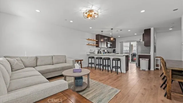 a living room with furniture a rug and a wooden floor