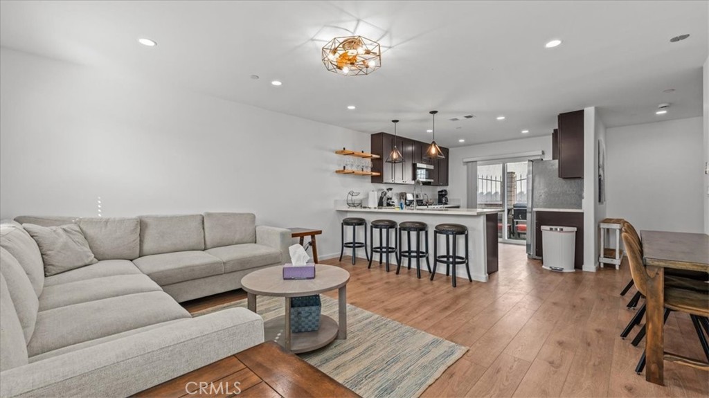 1475 North Holly Avenue Colton, CA 92324 - Photo 6 of 45 a living room with furniture a rug and a wooden floor