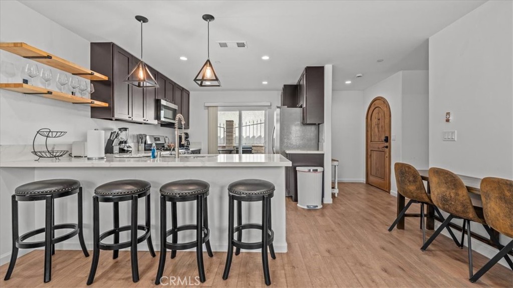 1475 North Holly Avenue Colton, CA 92324 - Photo 7 of 45 a dinning area with kitchen island granite countertop wooden floor and dining table
