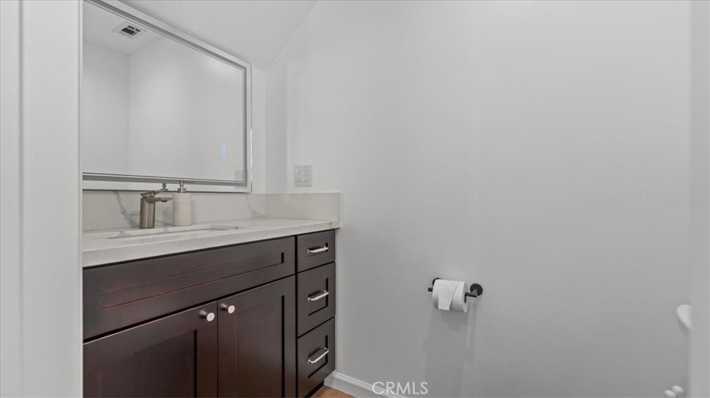 1475 North Holly Avenue Colton, CA 92324 - Photo 10 of 45 a bathroom with a sink and mirror