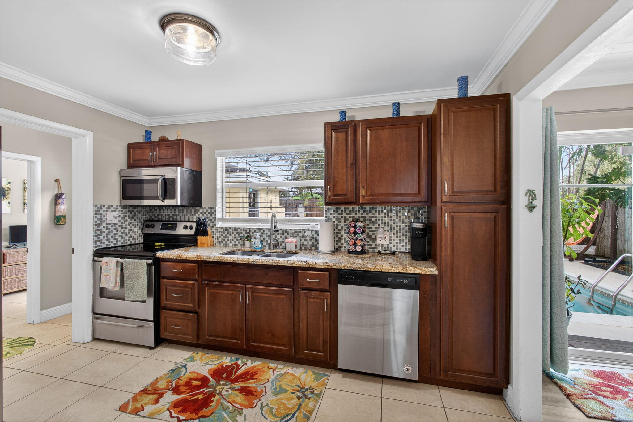 1901 Redbank Road North Palm Beach, FL 33408 - Photo 11 of 38 a kitchen with stainless steel appliances granite countertop a refrigerator and a stove top oven