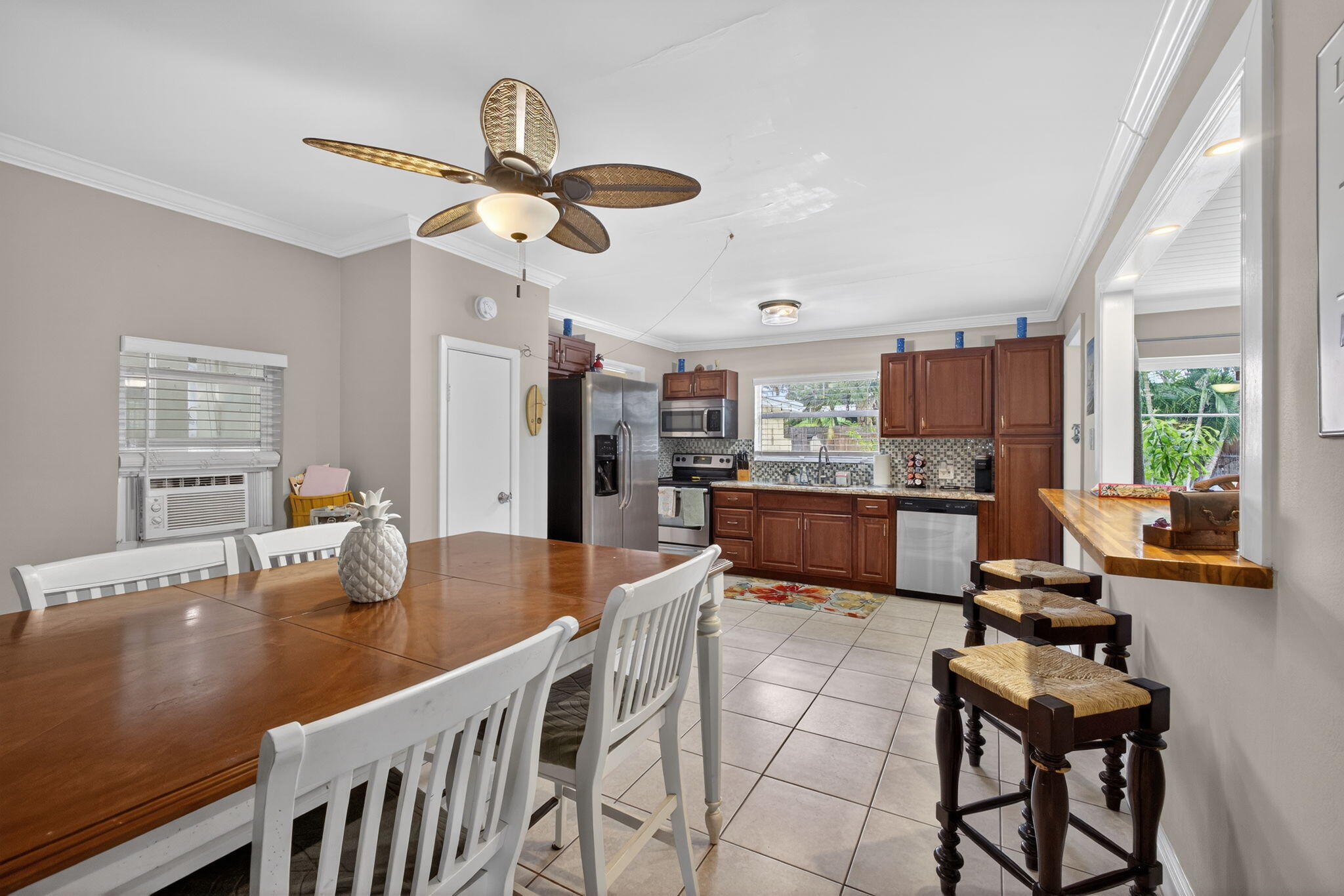 1901 Redbank Road North Palm Beach, FL 33408 - Photo 12 of 38 a kitchen with stainless steel appliances granite countertop a sink counter space and living room view