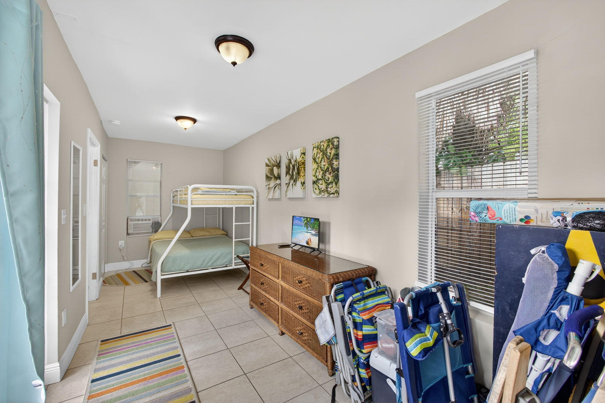 1901 Redbank Road North Palm Beach, FL 33408 - Photo 33 of 38 a bedroom with furniture and a window