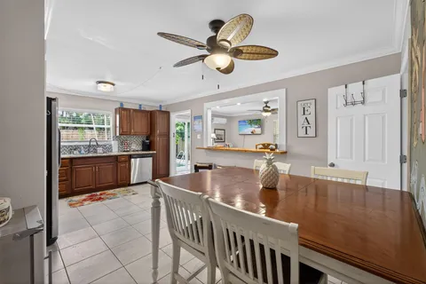 a kitchen with kitchen island granite countertop a sink cabinets and stainless steel appliances