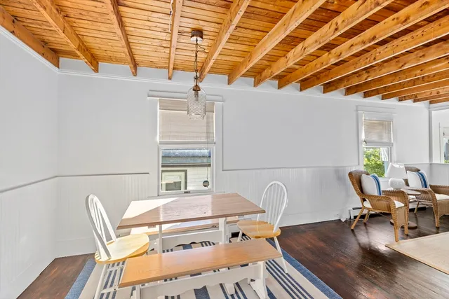 a dining room with furniture and wooden floor