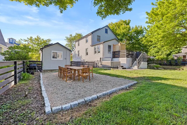 a view of a house with backyard and sitting area