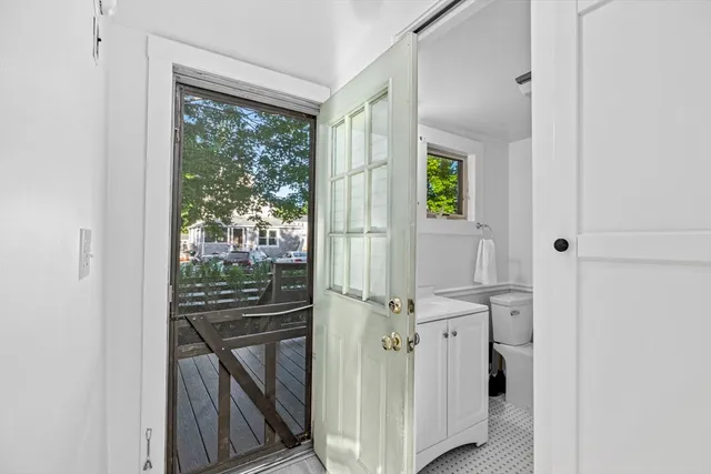 a view of a hallway with wooden floor and entryway