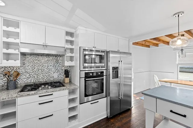 a kitchen with stainless steel appliances a stove a refrigerator and a sink