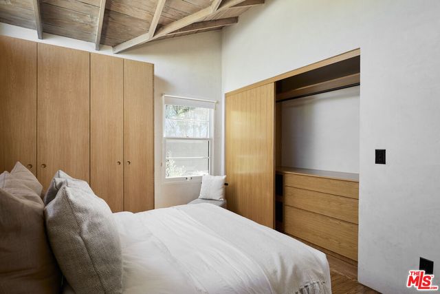 a bedroom with a bed and a cabinets