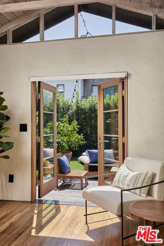 a view of a patio with couches table and chairs and potted plants