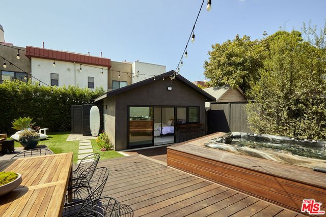 a view of a patio with table and chairs potted plants with wooden floor
