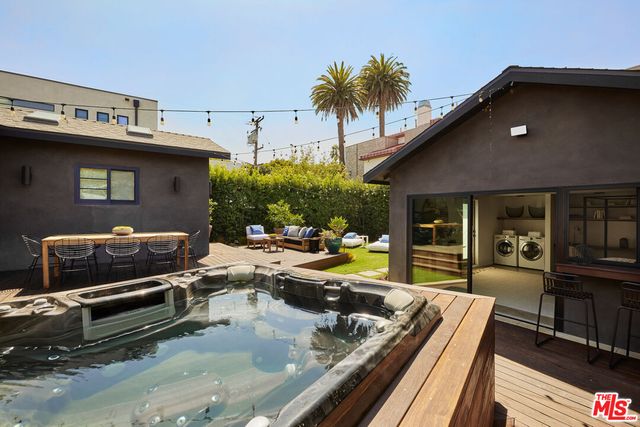 a view of a livingroom with furniture and floor to ceiling window