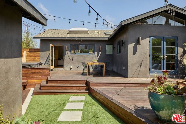 front view of a house with table and chairs