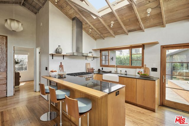 a kitchen with granite countertop a sink and wooden cabinets