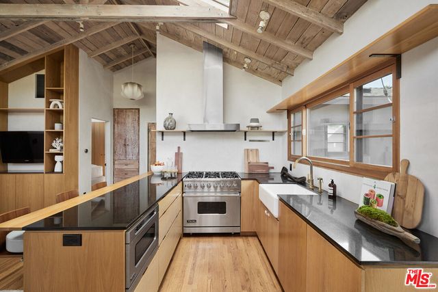 a kitchen with stainless steel appliances granite countertop a stove and a sink