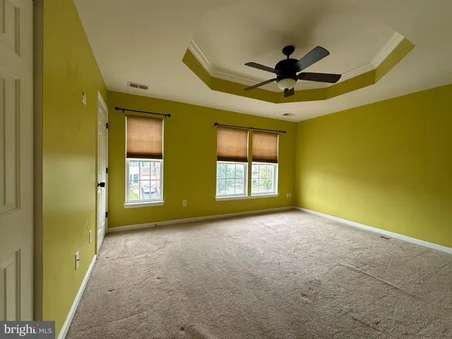 a view of a livingroom with a ceiling fan and window