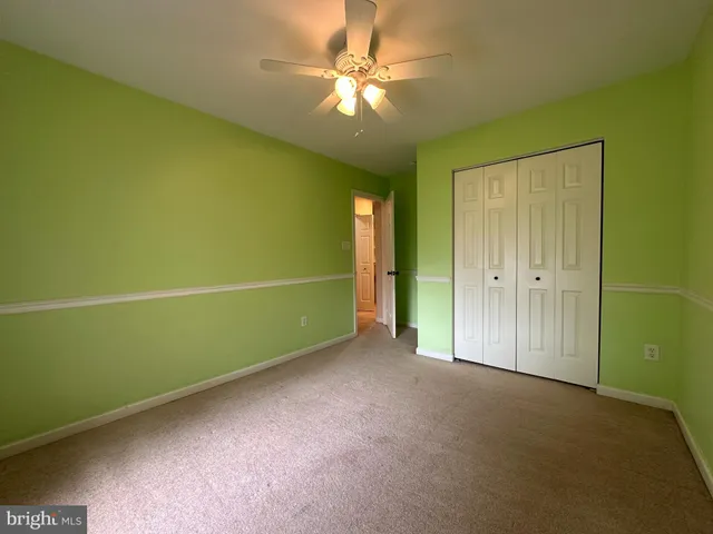 a view of empty room with fan and window