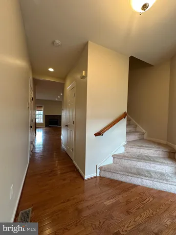 a view of entryway and hall with wooden floor