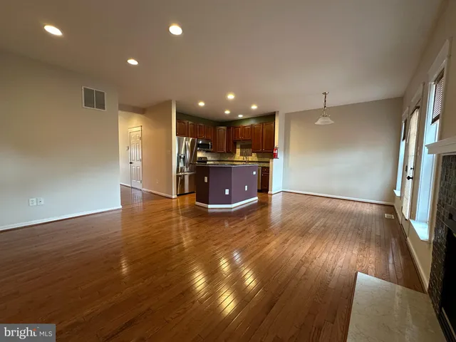 a view of kitchen and a sink with wooden floor