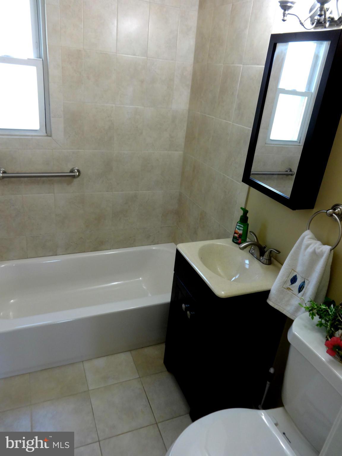 502 Royalton Road Silver Spring, MD 20901 - Photo 14 of 22 a bathroom with a sink vanity mirror and toilet