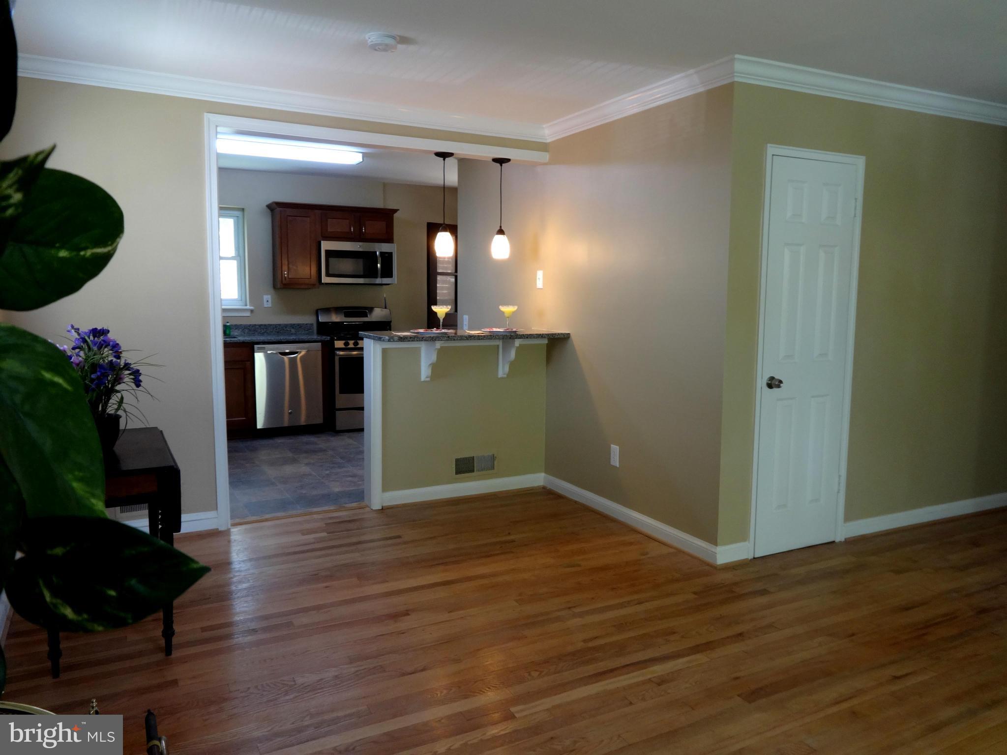502 Royalton Road Silver Spring, MD 20901 - Photo 5 of 22 a view of a living room with wooden floor and kitchen view