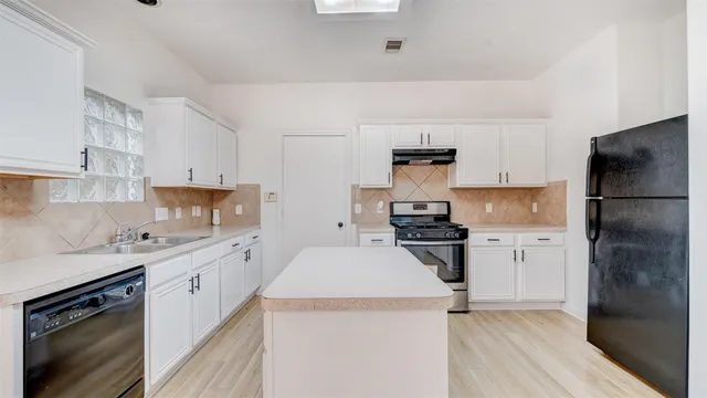 a kitchen with a refrigerator stove and sink