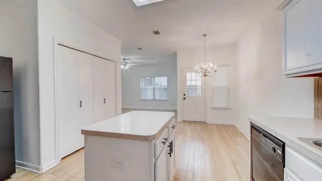 a view of a kitchen cabinets and wooden floor