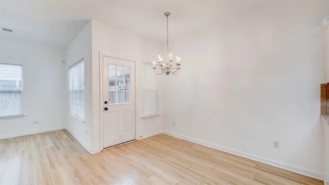 a kitchen with a refrigerator and a stove top oven