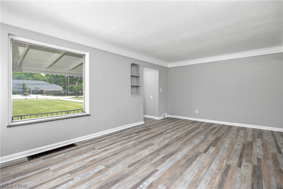 7030 Pearl Road Cleveland, OH 44130 - Photo 18 of 34 Unfurnished room with built in features and wood-type flooring